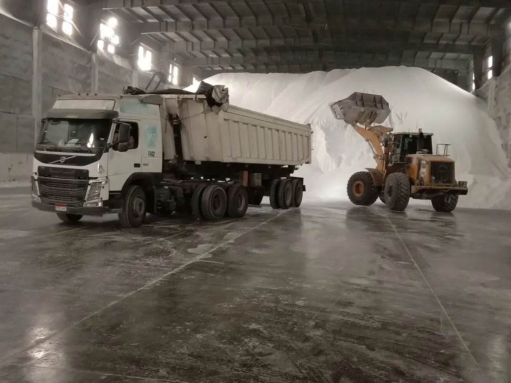 Inside a dedicated closed warehouse at Adabeyea Port, where a wheel loader feeds urea into a tipper truck