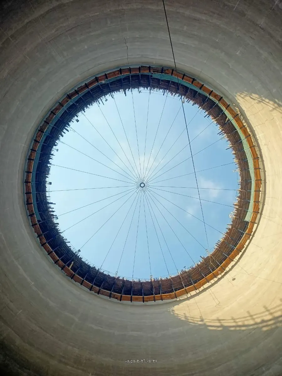 Interior of a silo looking straight up through the circular roof opening to the sky
