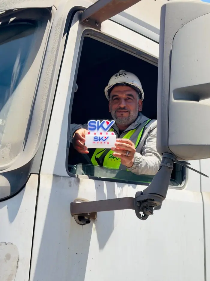 Driver holding a Sky Ports badge