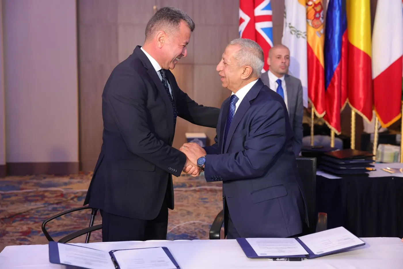 Sky Ports and AASTMT representatives greeting each other at the signing table