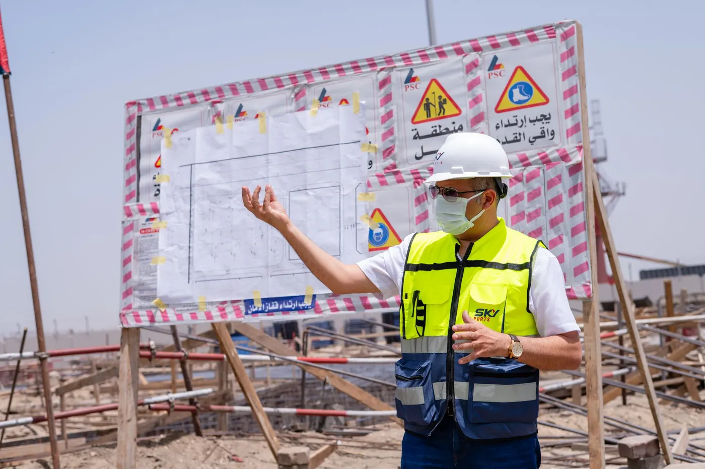 A Sky Ports engineer explaining site plans to trainees at the terminal
