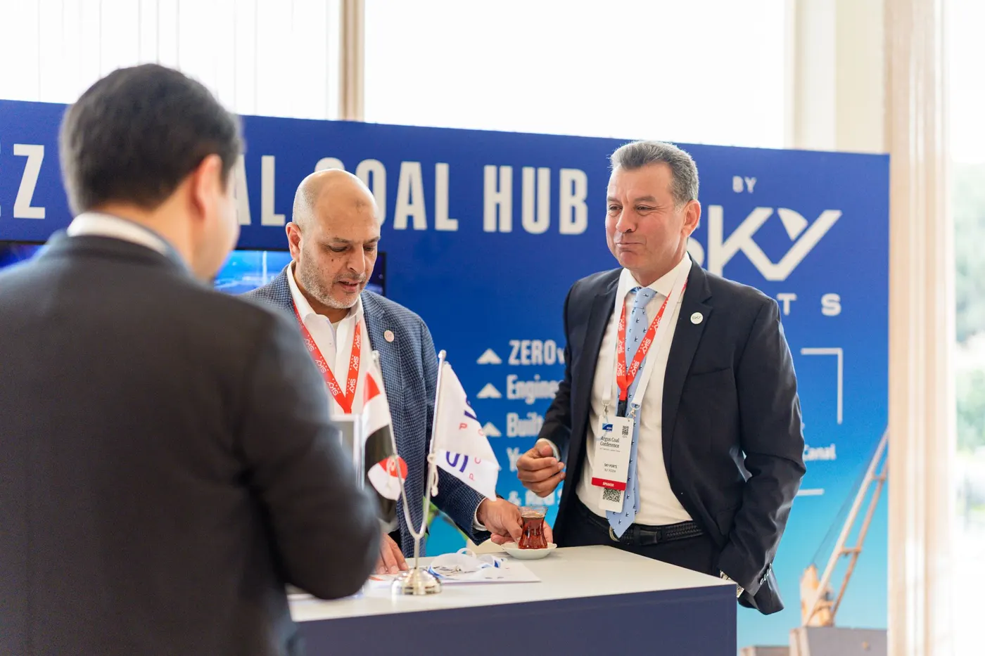 Aly Assem speaking with an attendee at the Sky Ports stand