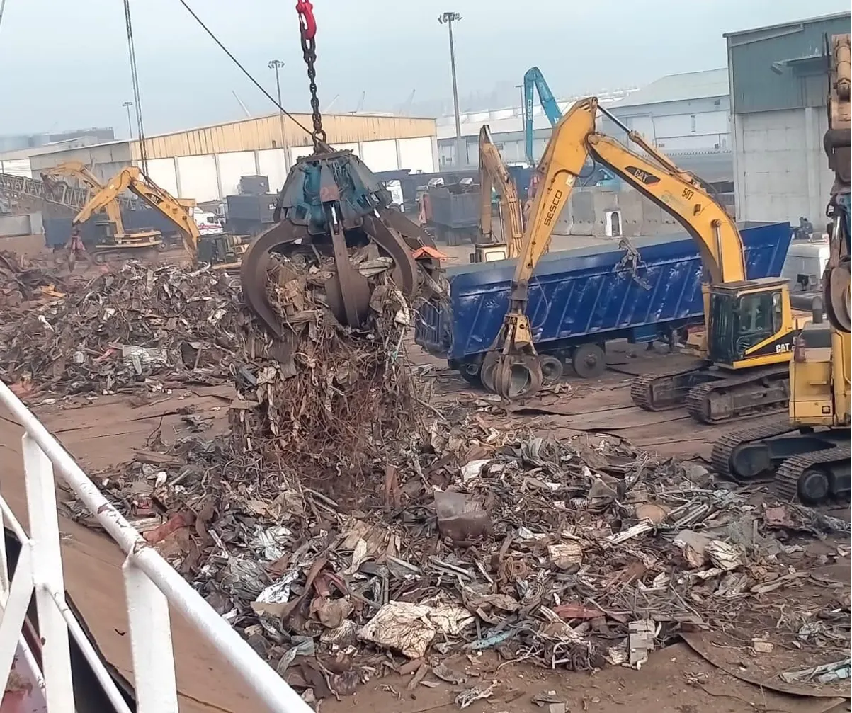 Grab crane rehandling scrap from a large accumulated pile
